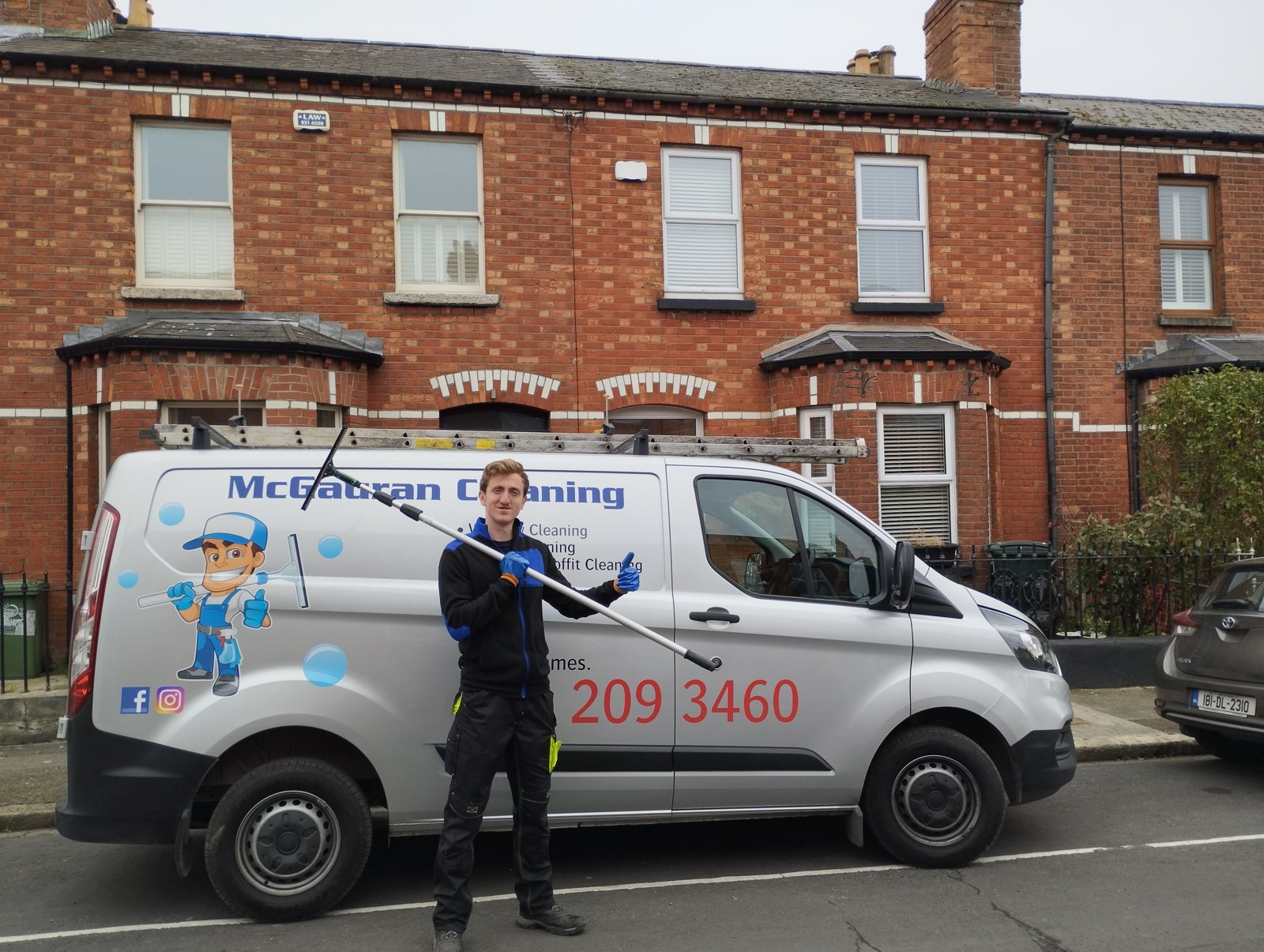James from McGauran Cleaning with his window cleaning pole beside the company van